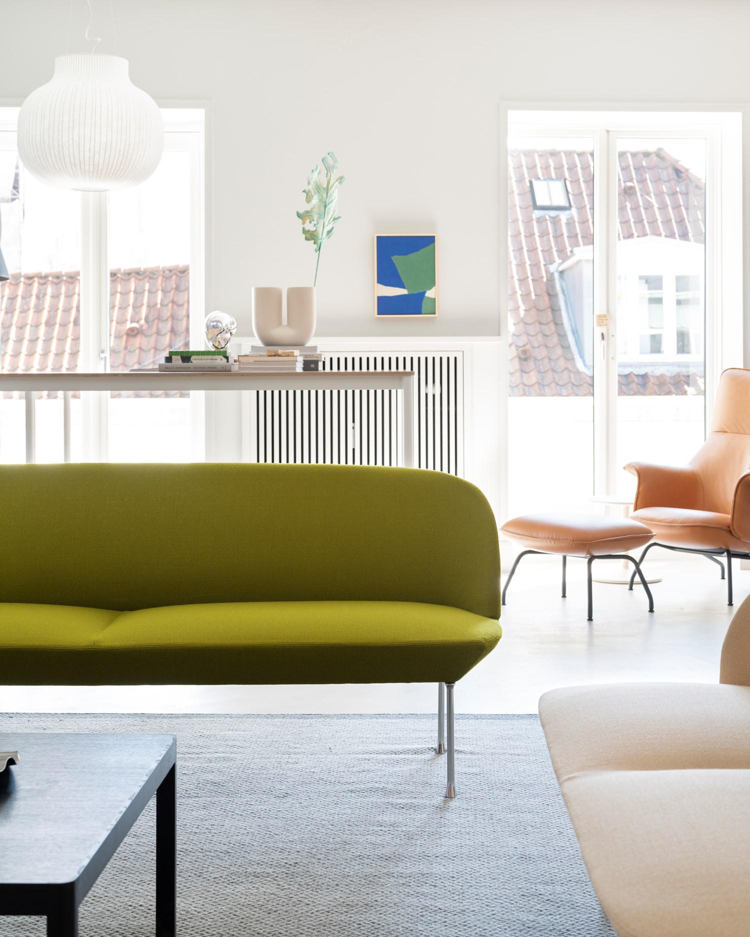 Muuto HQ showroom, showcasing a curated interior with contemporary furniture and lighting in a modern, open setting. Muuto HQ showroom, showcasing a curated interior with contemporary furniture and lighting in a modern, open setting.